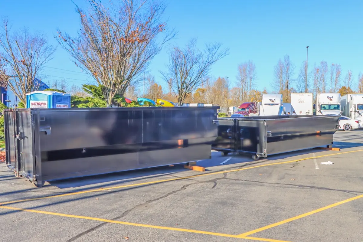 Professional dumpster rental service with roll-off container on residential driveway in Spartanburg